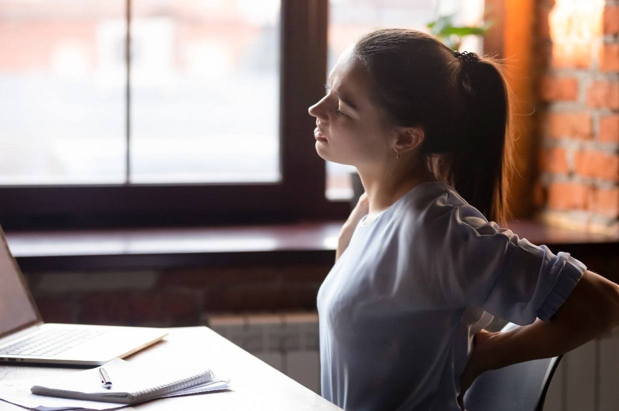 young-women-sitting-on-a-chair-taking-a-break-because-of-back-pain.jpg